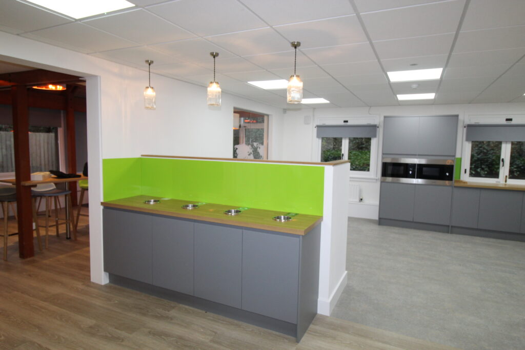 grey kitchen units with lime green splashback