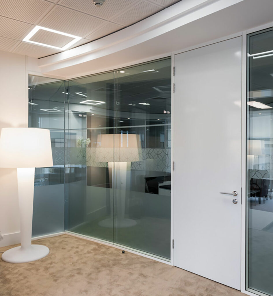 glass paritioning, tall white door and standing white lamp