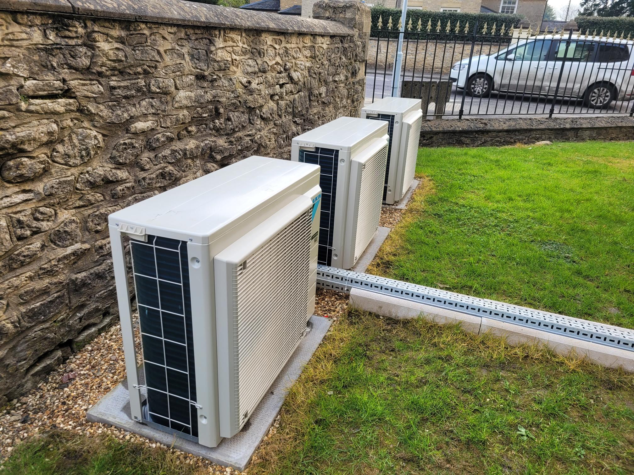 Air conditioning units located outside a stone building