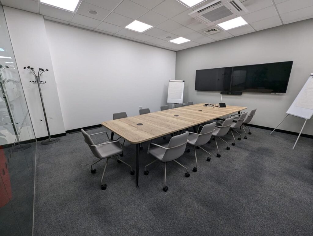 Meeting room with large table and 10 chairs