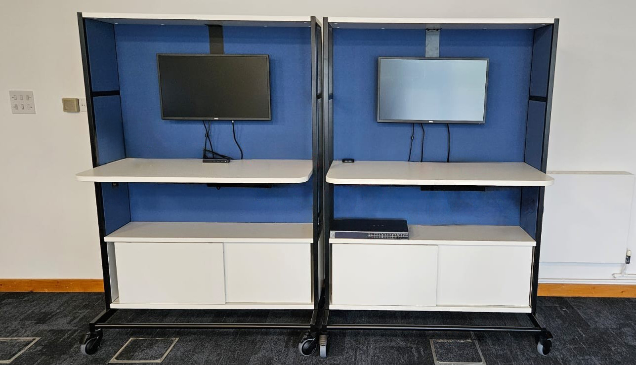Workstations with storage, monitor arms and monitors and white worktops
