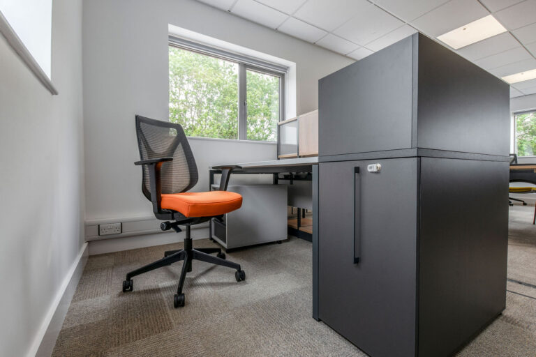 Grey Desk and desk end pull out storage unit with task chair with orange seat pad