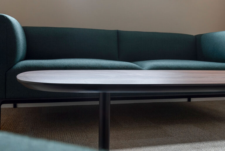 Close up images of a coffee table and green sofa