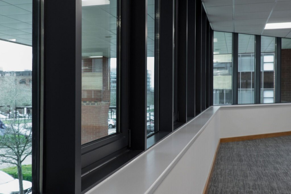 Window frames of office sprayed in anthracite grey